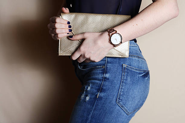 trendy girl with gold clutch and watch beauty, fashion concept. - woman horloge stockfoto's en -beelden