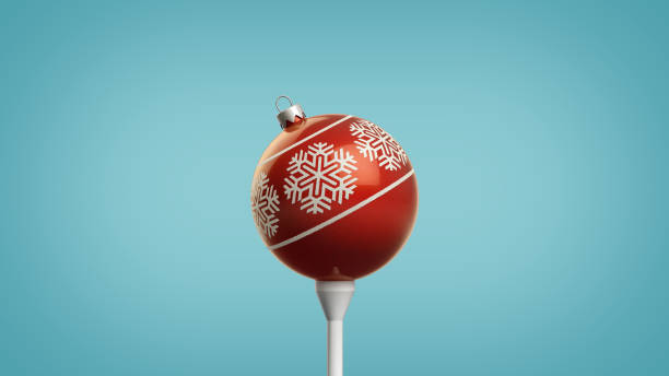 Trendy Retro 3D Illustration of Shiny Red Christmas Ornament with a Snowflake Design on a Golf Tee Isolated on a Fresh Blue Background with Clipping Path stock photo