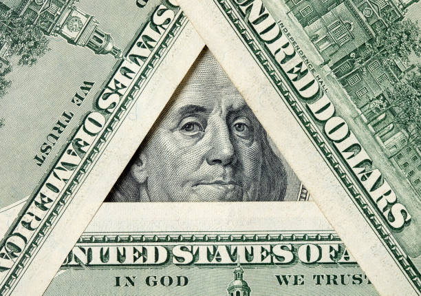 Triangle made of $100 bills with Benjamin Franklin inside stock photo