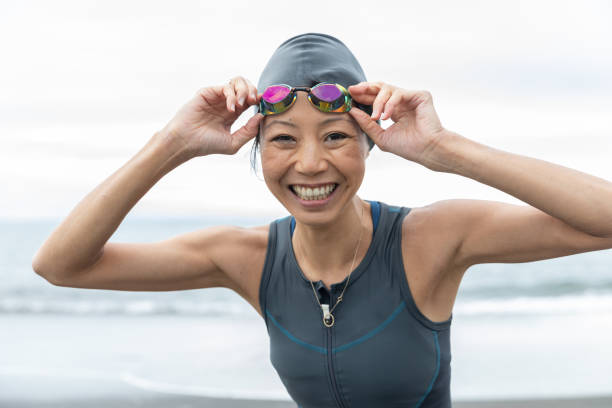 Triathlete woman coming out from sea stock photo