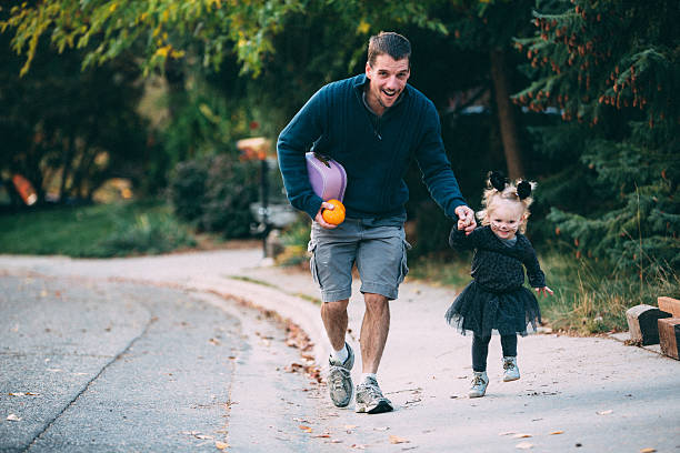 Trick or treating with dad stock photo