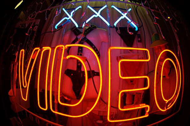Triple X-Rated Video Bulge Neon Sign at Night stock photo