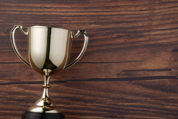 trophy on wood background top view of award trophy on the wood background hunting trophy stock pictures, royalty-free photos & images