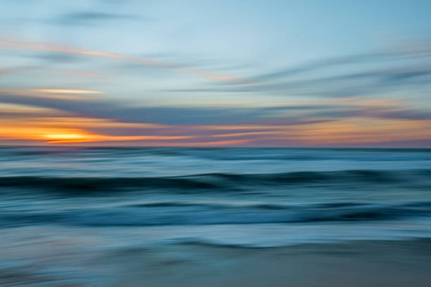 Tropical beach sunset, abstract. Beautiful sea, and colorful sky. Motion blur, line art stock photo