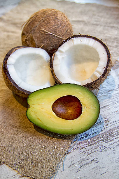 тропические фрукты. авокадо и кокос - mitrovic стоковые фото и изображения