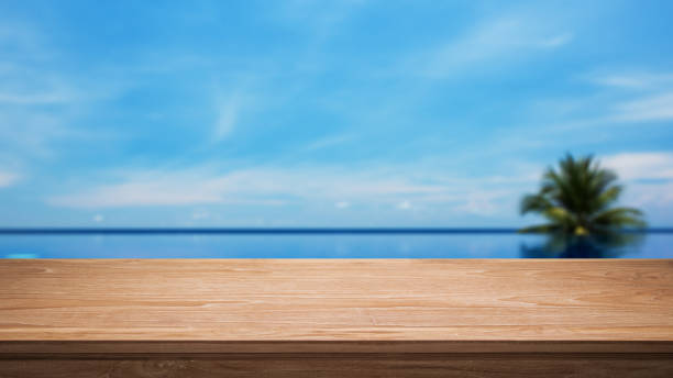 Tropical Infinity Pool And Empty Wooden Table stock photo