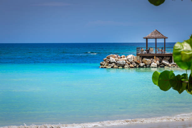 Tropical paradise: caribbean beach with pier and gazebo, Montego Bay, Jamaica stock photo