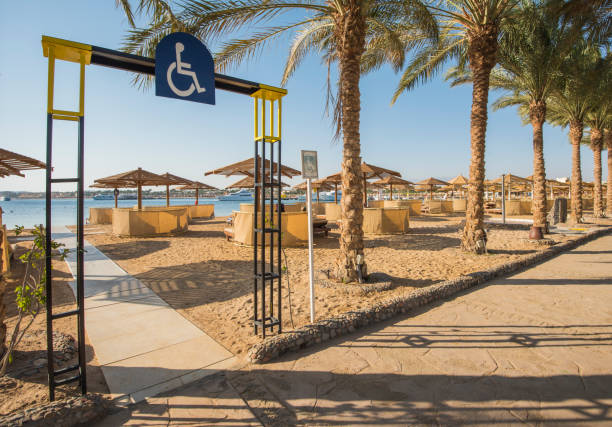 Tropical sandy beach with disabled access at a hotel resort stock photo