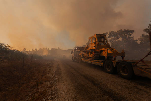Truck Carrying Bulldozer to Wild Fire Area stock photo