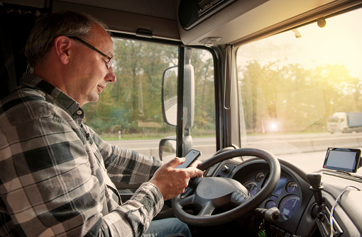 Truck Driver Using Mobile Phone Stock Photo - Download Image Now - iStock