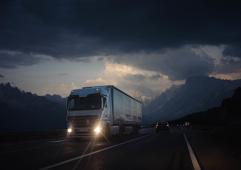 Truck transporting goods on the highway in a dramatic scenery