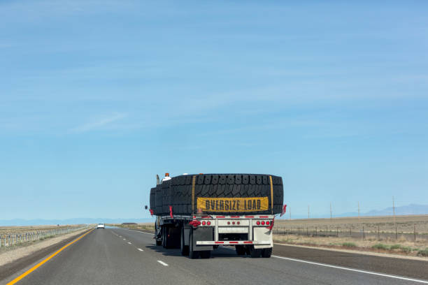 Truck with oversize load driving at interstate highway of nevada utah USA America Truck with oversize load driving at interstate highway of nevada utah USA America oversized object stock pictures, royalty-free photos & images