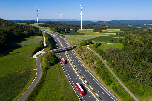 Trucks on Highway and Wind Turbines, Aerial View