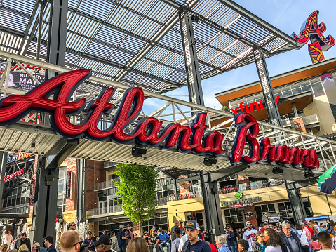 April 2018, Atlanta, Georgia. Truist Park is home to the Atlanta Braves. People mill about outside the park, waiting for the game to start.