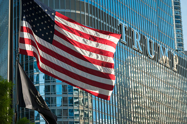 Trump Chicago, USA - August 24, 2016: An American and POW flag flying on the Riverwalk late in the day with the Trump Tower in the background. donald trump stock pictures, royalty-free photos & images
