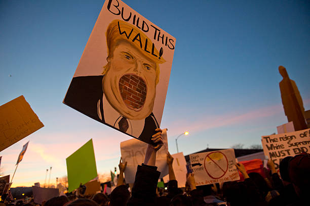 Trump Protest Signs Chicago,Illinois, USA - March 11th, 2016: Protest sign at the Anti Trump rally at University of Illinois at Chicago, during twilight. donald trump stock pictures, royalty-free photos & images