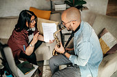 Mother teaching to son how to play saxophone