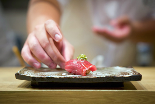 Tuna Sushi with fresh wasabi served on ceramic plate. Enjoy Omakase experience at Japanese Sushi Restaurant.