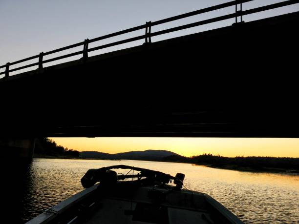 Tupper Lake Boat Highway Underpass Silhouette at Sunset, NY Tupper Lake Boat Highway Underpass Silhouette at Sunset, NY tupper lake stock pictures, royalty-free photos & images