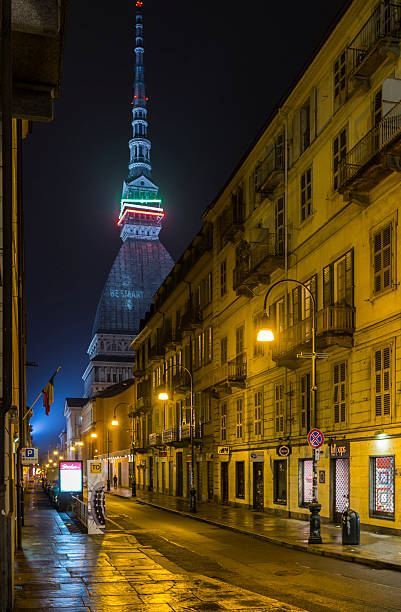 Turin (Italy). Via Montebello at night and Mole Antonelliana stock photo