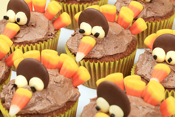 Turkey Cupcake Platter Three turkey cupcakes on yellow background. turkey cupcakes stock pictures, royalty-free photos & images