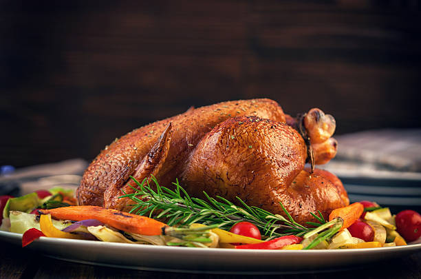 Turkey Dinner Roasted turkey served on plate with a variety of vegetables, ready for dinner on Thanksgiving thanksgiving turkey stock pictures, royalty-free photos & images