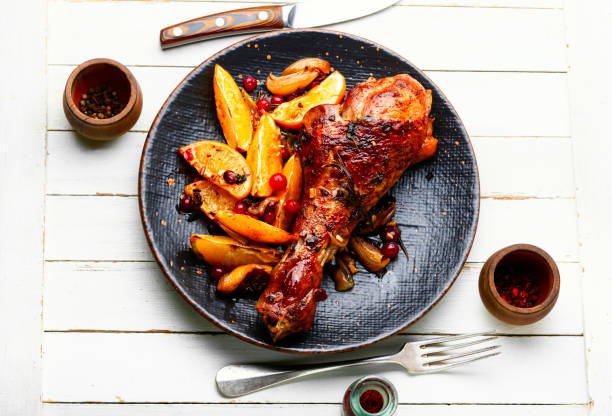 Turkey leg with orange, fried meat stock photo