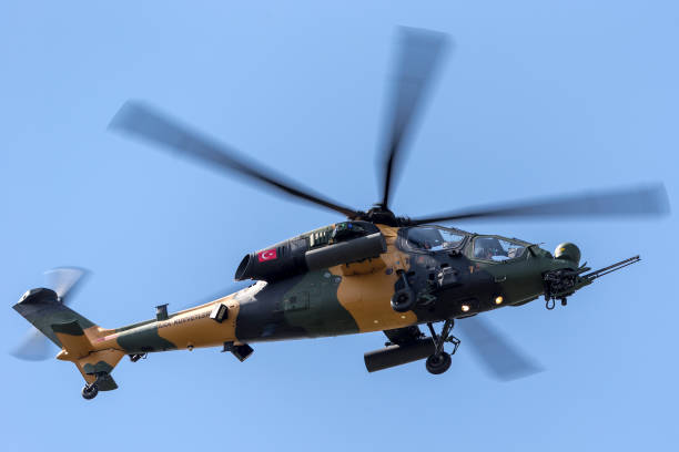 Turkish Army TAI T129 Attack Helicopter on approach to land at Farnborough Airport. Farnborough, UK - July 16, 2014: Turkish Army TAI (AgustaWestland) T129 ATAK Attack Helicopter on approach to land at Farnborough Airport. defense industry stock pictures, royalty-free photos & images