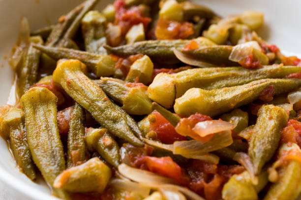 Turkish Food Okra Dish with Tomatoes and Onion Slices / Bamya Turkish Food Okra Dish with Tomatoes and Onion Slices / Bamya. Traditional Organic Food. okra plants pics stock pictures, royalty-free photos & images
