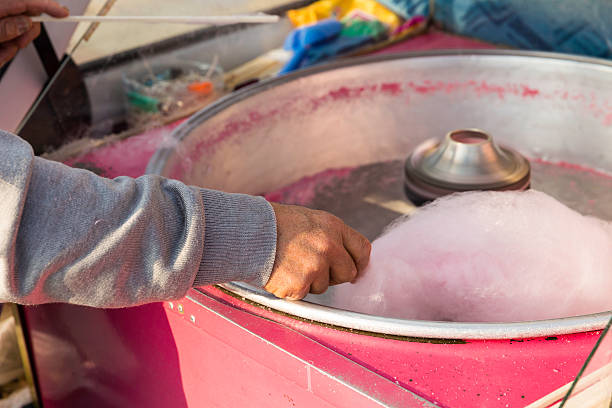Turkish peddler manufacturing cotton candy in a floss machine stock photo