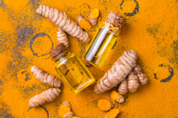 Turmeric essential oil, orange root and powder, beauty and spa stock photo