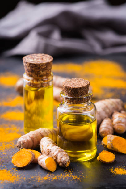 Turmeric essential oil, orange root and powder, beauty and spa stock photo