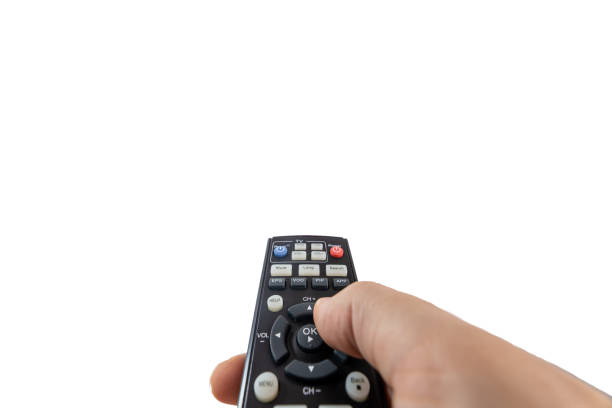 Turning on a TV with a remote control stock photo