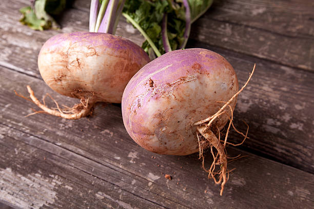 Turnips on a Table Fresh turnips on a wooden tabletop. turnip stock pictures, royalty-free photos & images