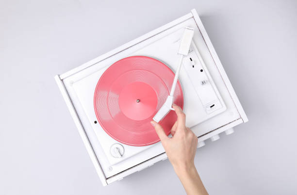 DJ Turntable, Hand Placing Tonearm on white Vinyl Record. Music concept. Top View stock photo