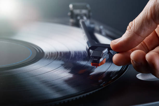 Turntable LP record player playing vinyl Turntable LP record player playing vinyl with creamy bokeh at the background turntable stock pictures, royalty-free photos & images