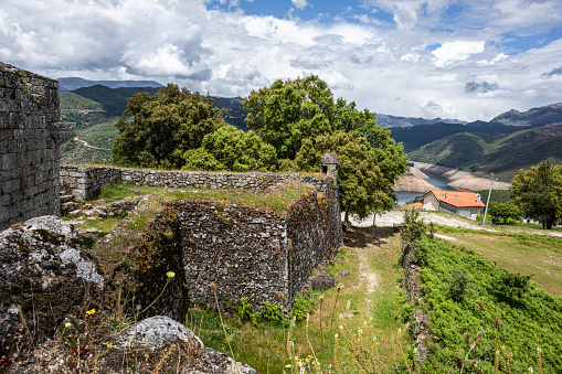June 3, 2022, Lindoso, Viana do Castelo, Portugall: A turret on the wall of a medieval Castle with the Lidoso reservoir in the background. Lindoso, Viana do Castelo, Portugall.