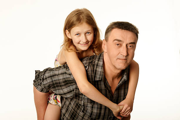 Twelve year old daughter hugging her father stock photo