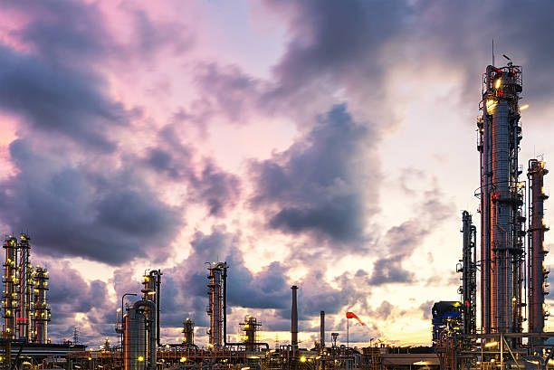 Twilight scene of oil and gas refinery skyline Violet and blue twilight sunset scene of oil and gas refinery skyline oil refinery factory stock pictures, royalty-free photos & images