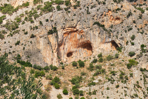 Twin Caves climbing sector in Leonidio, Arcadia, Peloponnese, Greece, with red limestone rock. stock photo