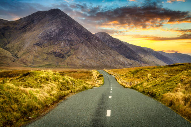 Twisty road in Connemara Moutains at sunset Twisty road in Connemara Moutains at sunset, Ireland connemara stock pictures, royalty-free photos & images