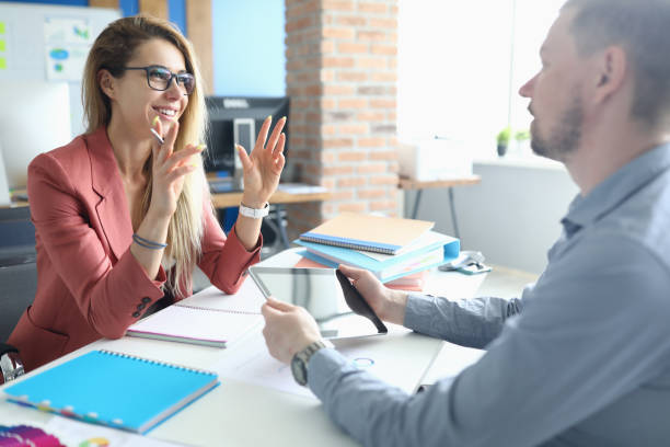 Two adult business people make work interview against office background Two adult business people make work interview against office background.One on one meeting concept. active listening stock pictures, royalty-free photos & images