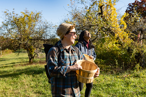 Two female friends of different ethnicities spend an autumn day on the organic Stone Ridge Orchard farm in upstate New York.
