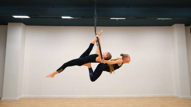 Two aerial acrobats on aerial hoop, series of photos stock photo