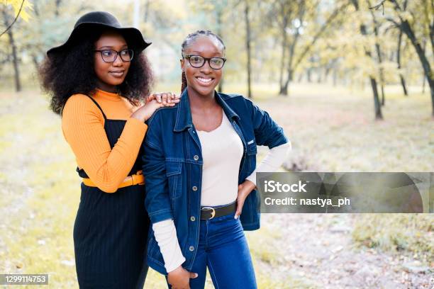 two african american sisters women having fun in the park outdoors