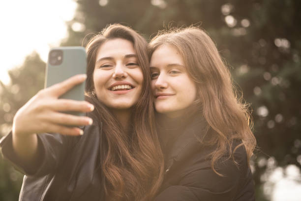Two beautiful girls taking selfies stock photo