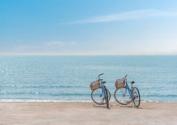 two bicycle on the seaside - fietsen strand stockfoto's en -beelden