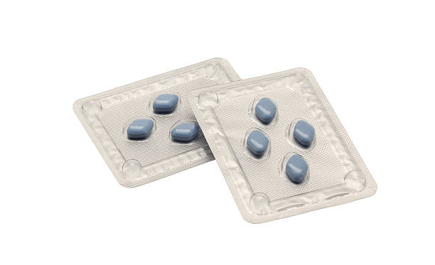 Two blister packs of blue Viagra anti-impotence tablets Two blister packs of blue Viagra anti-impotence tablets isolated on a white background anti impotence tablet stock pictures, royalty-free photos & images