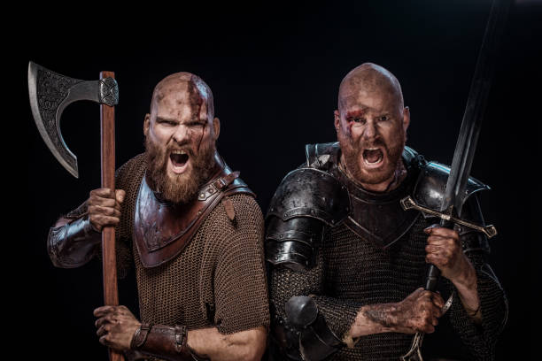 Two Bloody Viking warriors in studio shot stock photo