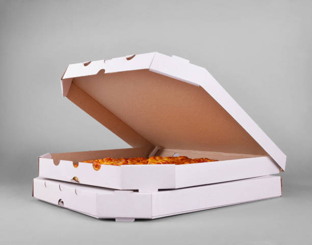 Two boxes of juicy hot margarita pizza on gray background stock photo